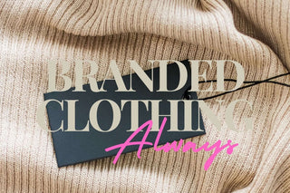 Branded clothing tag on soft knit fabric with the phrase 'Branded Clothing Always!' in stylish font.