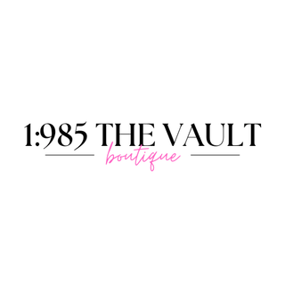 Logo of 1985 THE VAULT boutique featuring elegant typography and a pink accent.