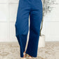Model wearing Little Strolls Straight Leg Trousers in Royal Blue with a stylish top and casual sandals.