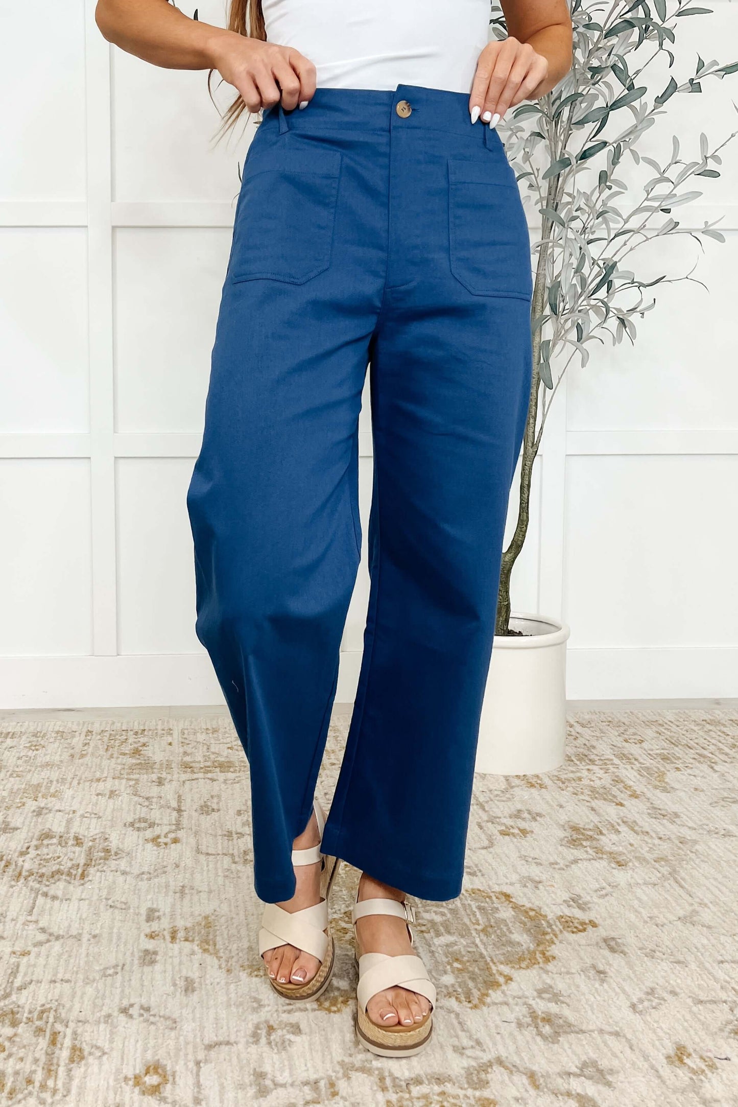 Model wearing Little Strolls Straight Leg Trousers in Royal Blue with a stylish top and casual sandals.