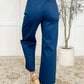 Back view of a woman wearing royal blue Little Strolls straight leg trousers with a cropped wide leg style.