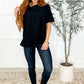 Model wearing The Layback Relaxed Basic Tee in Black with jeans, showcasing its oversized fit and stylish look.