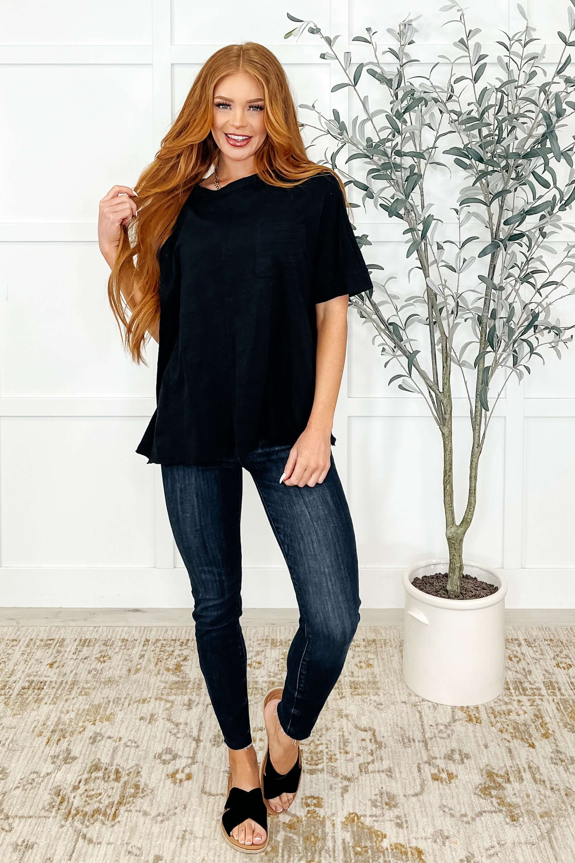 Model wearing The Layback Relaxed Basic Tee in Black with jeans, showcasing its oversized fit and stylish look.